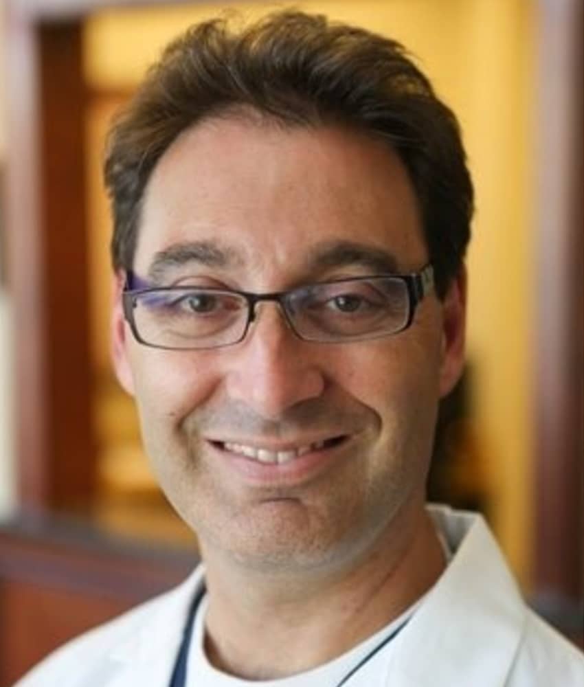 Jonathan Zaidan Wearing Glasses And Smiling At The Camera