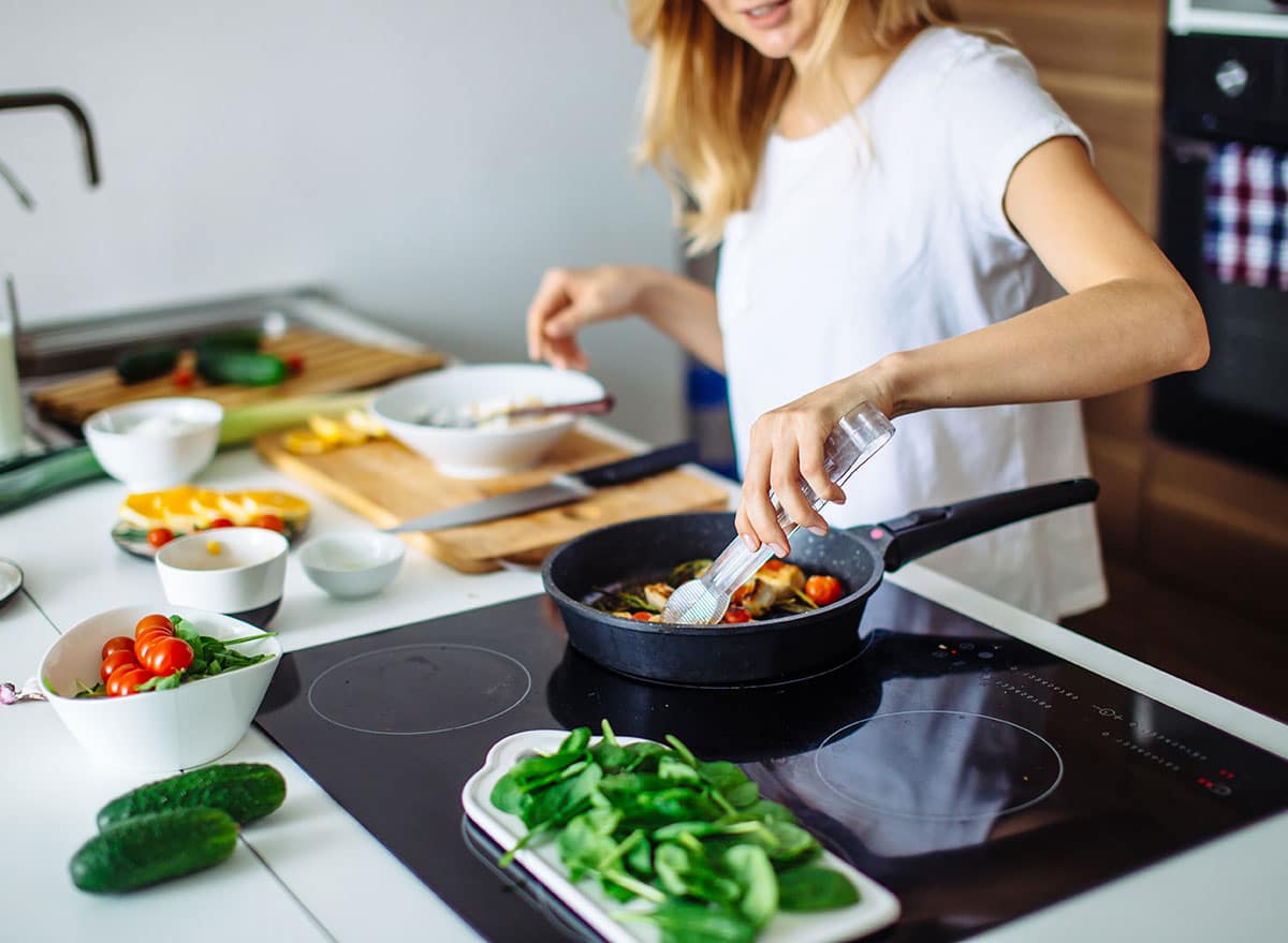 a woman preparing food in a kitchen