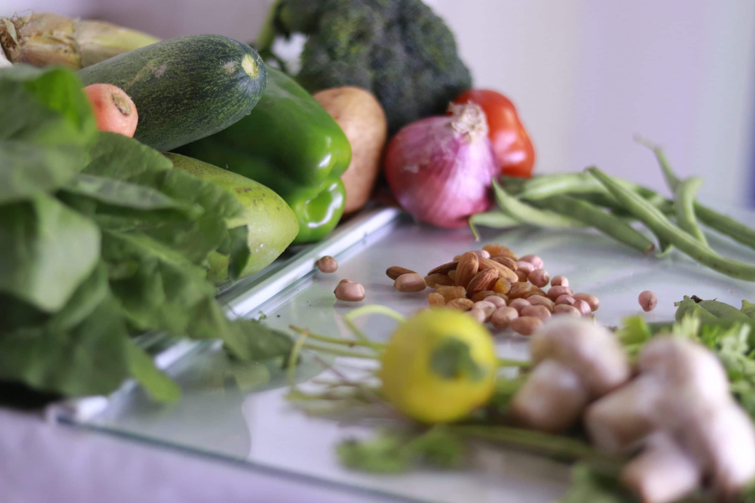 A set of fresh healthy groceries on a table represents the potential benefits of following an endometriosis diet