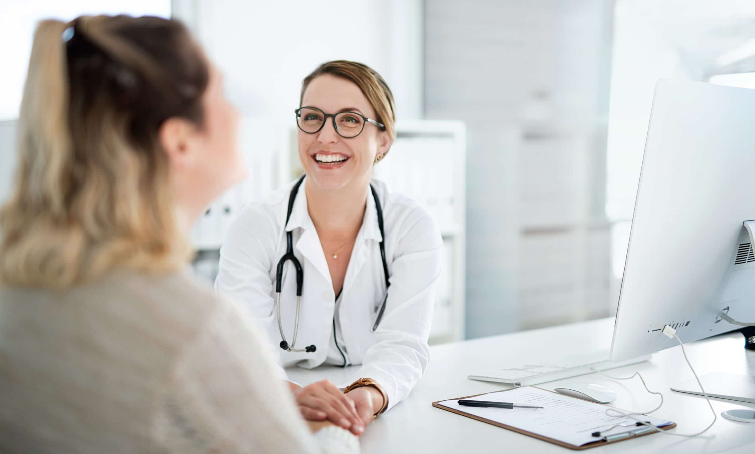A doctor holds hands with her patient to deliver compassionate endometriosis evaluation and pelvic pain treatment options